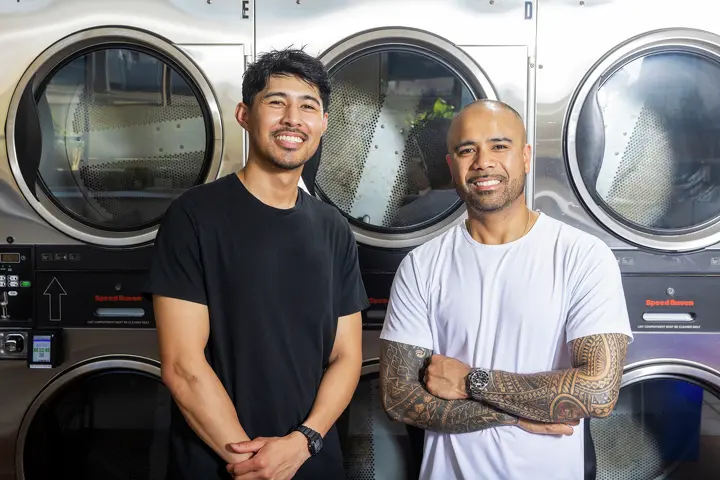 Brian, left, and Jonathan, the owners of The Laundry Hub, in front of the store washers.
